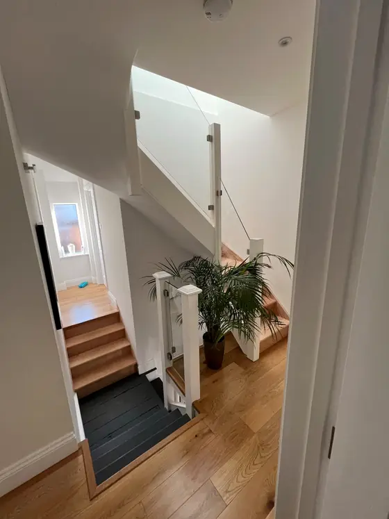 The glass panel on the timber staircase, seen from the landing